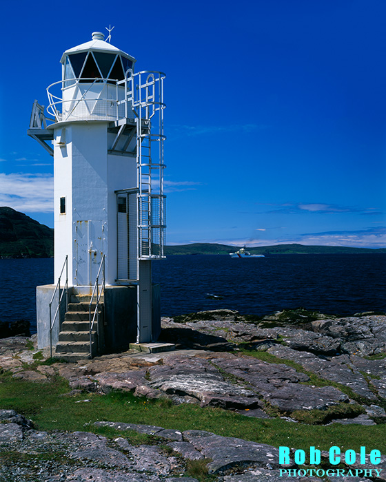 The lighthouse at Rubha Cadail stands on the rocky shore of Loch Broom near Rhue