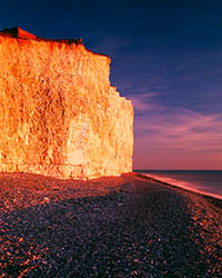A low winter sun illuminates the chalk cliffs at Birling Gap